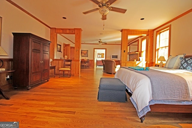 bedroom with ceiling fan, crown molding, and light hardwood / wood-style flooring