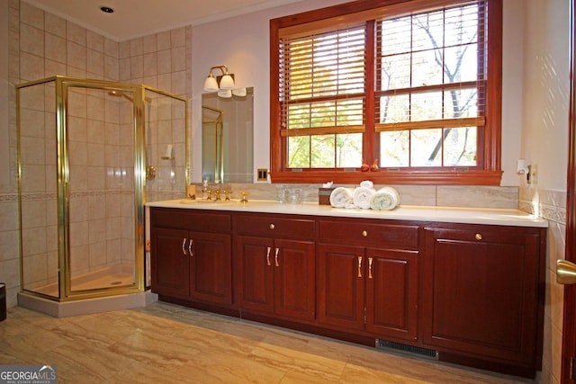 bathroom featuring an enclosed shower, crown molding, backsplash, tile floors, and double vanity