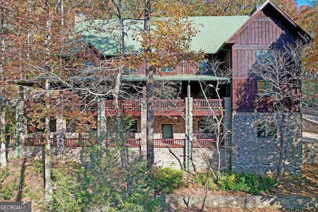 back of property featuring a balcony