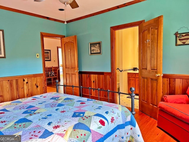 bedroom with ceiling fan, crown molding, and light hardwood / wood-style flooring