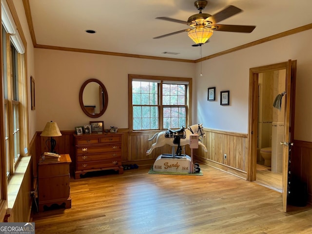 misc room featuring ceiling fan, crown molding, and light hardwood / wood-style flooring