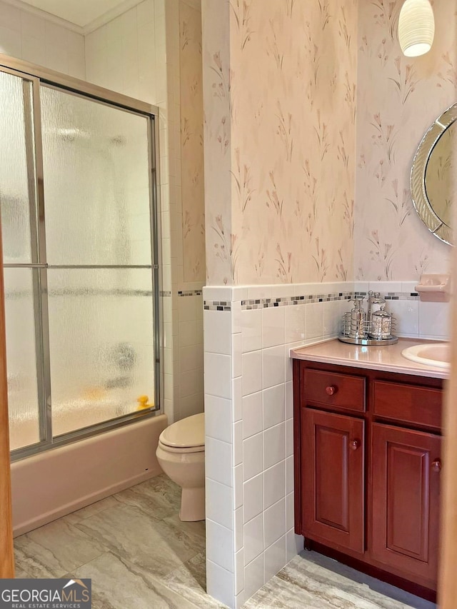 full bathroom with toilet, vanity, enclosed tub / shower combo, tile walls, and tile flooring