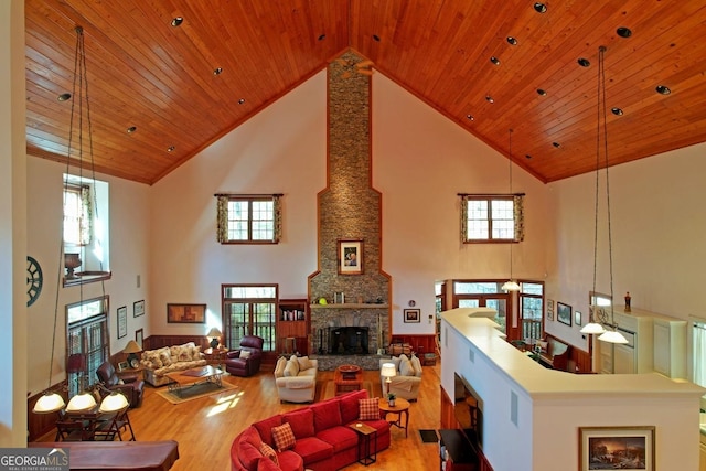 living room featuring high vaulted ceiling, light hardwood / wood-style flooring, and wood ceiling