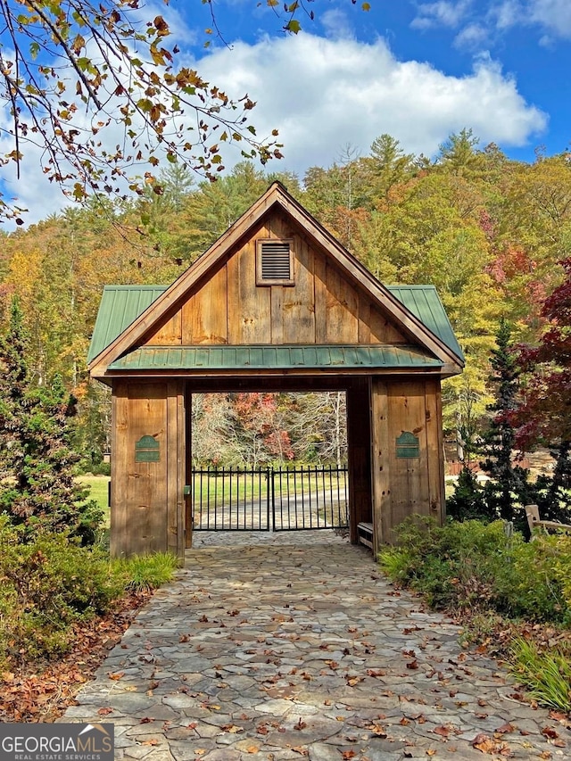 view of gate featuring an outdoor structure