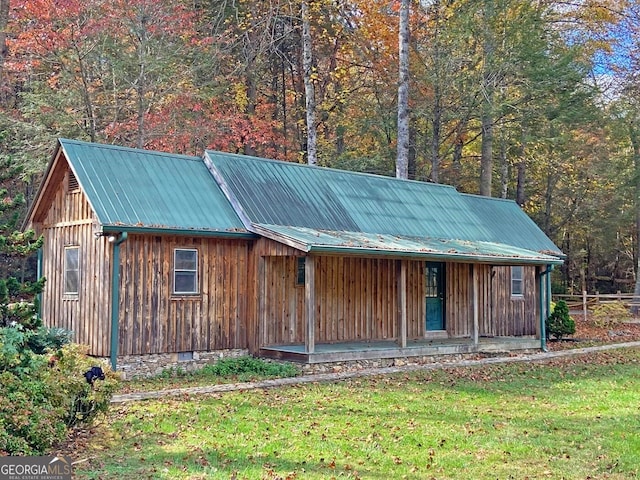 view of shed / structure featuring a porch and a yard