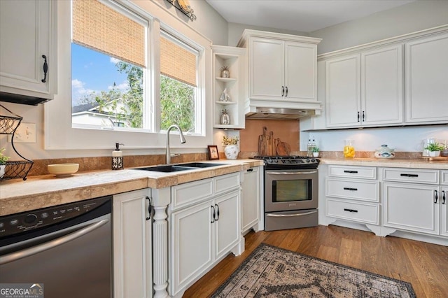 kitchen featuring appliances with stainless steel finishes, sink, light wood-type flooring, and white cabinets