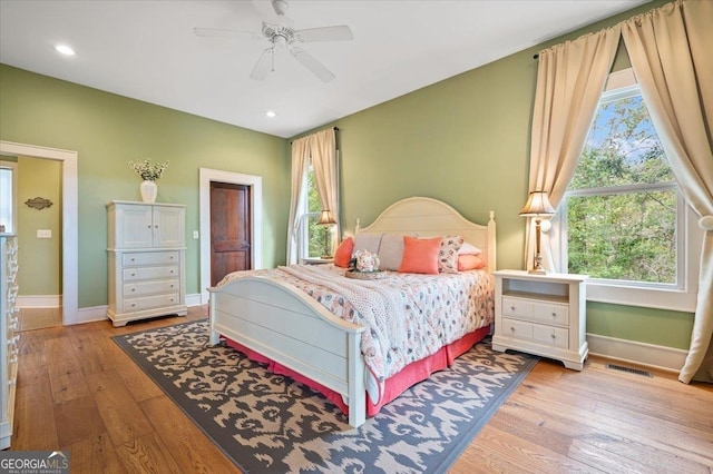 bedroom with ceiling fan and light hardwood / wood-style flooring