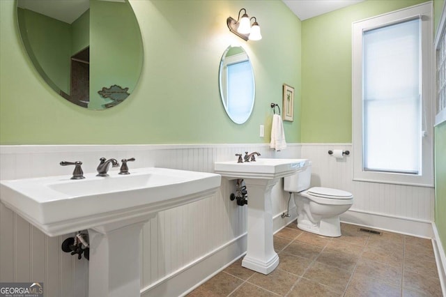 bathroom featuring sink, tile floors, and toilet