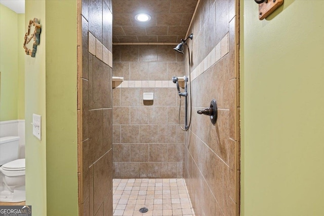 bathroom featuring toilet and tiled shower