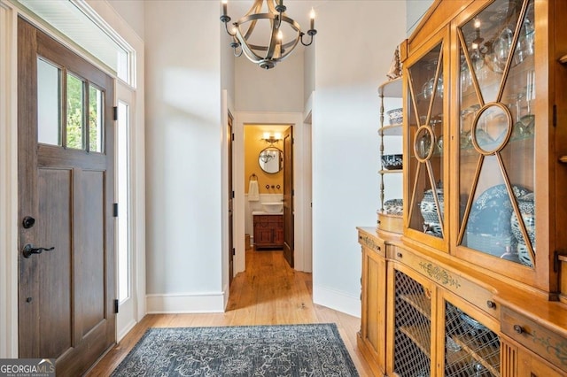 foyer featuring light hardwood / wood-style flooring and an inviting chandelier