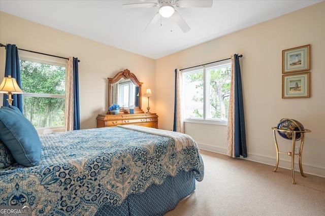 bedroom with ceiling fan and light carpet