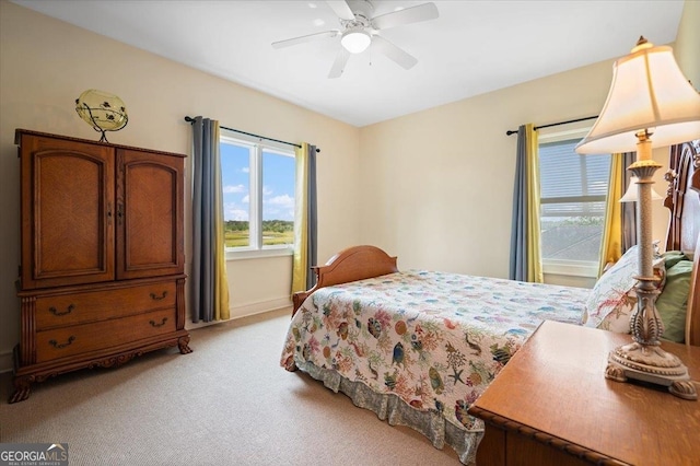 bedroom featuring light colored carpet and ceiling fan