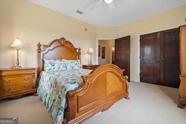 carpeted bedroom with ceiling fan and a closet