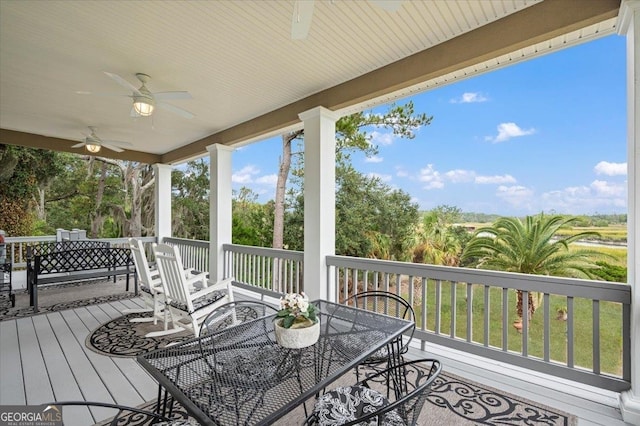 wooden deck featuring ceiling fan