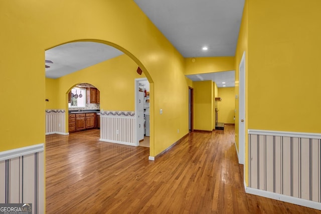 805 Quail Cove Cir, Warne, NC 28909 - corridor featuring wood finished floors, arched walkways, and a sink