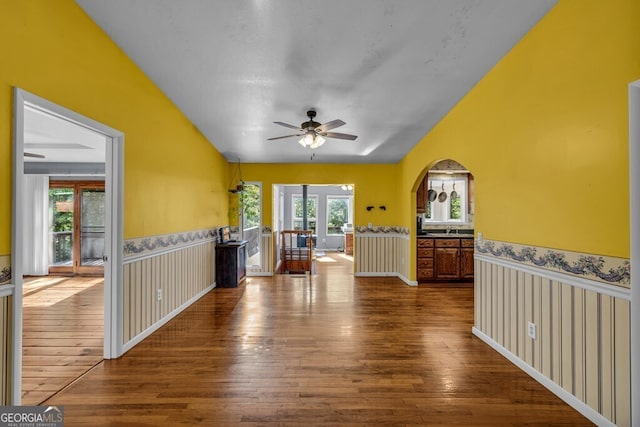 805 Quail Cove Cir, Warne, NC 28909 - spare room featuring lofted ceiling, a ceiling fan, hardwood / wood-style flooring, arched walkways, and a wainscoted wall