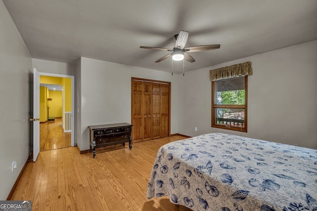 805 Quail Cove Cir, Warne, NC 28909 - bedroom with light wood-style flooring, a closet, baseboards, and a ceiling fan