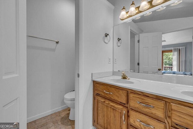 805 Quail Cove Cir, Warne, NC 28909 - bathroom featuring double vanity, toilet, and baseboards