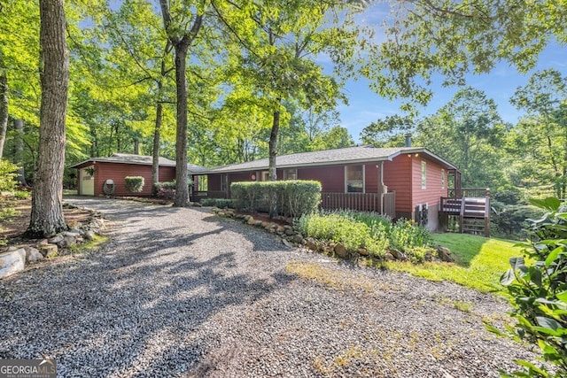 805 Quail Cove Cir, Warne, NC 28909 - view of front facade featuring gravel driveway and a wooden deck