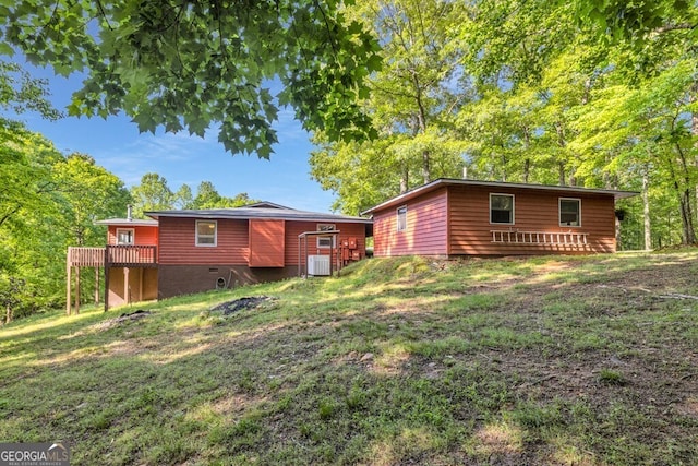 805 Quail Cove Cir, Warne, NC 28909 - back of house with central AC, a wooden deck, and a lawn