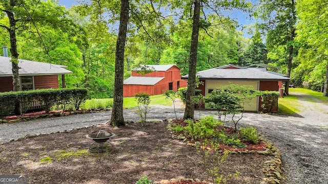 805 Quail Cove Cir, Warne, NC 28909 - view of yard with gravel driveway, an outdoor structure, and an attached garage
