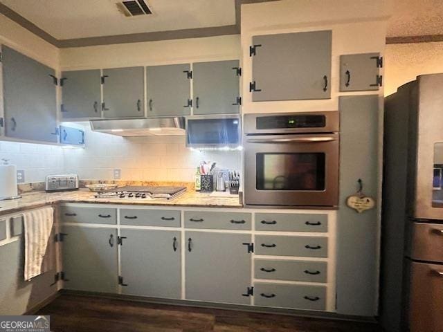 kitchen with tasteful backsplash, dark hardwood / wood-style floors, stainless steel appliances, and range hood