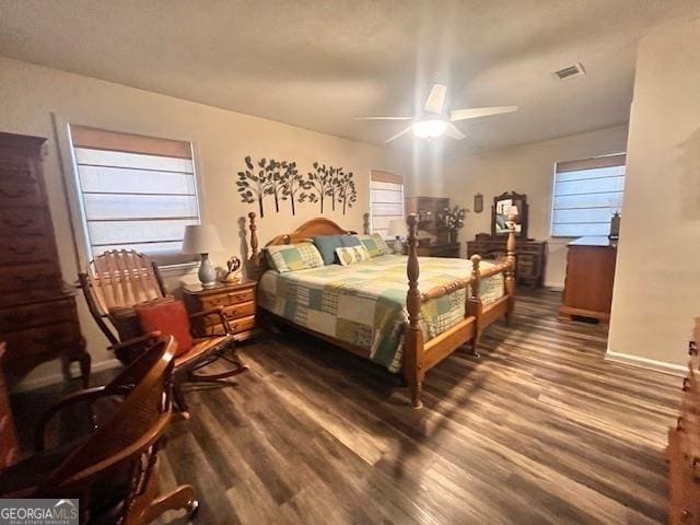 bedroom with ceiling fan and dark hardwood / wood-style floors