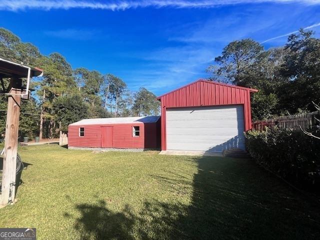 garage featuring a lawn