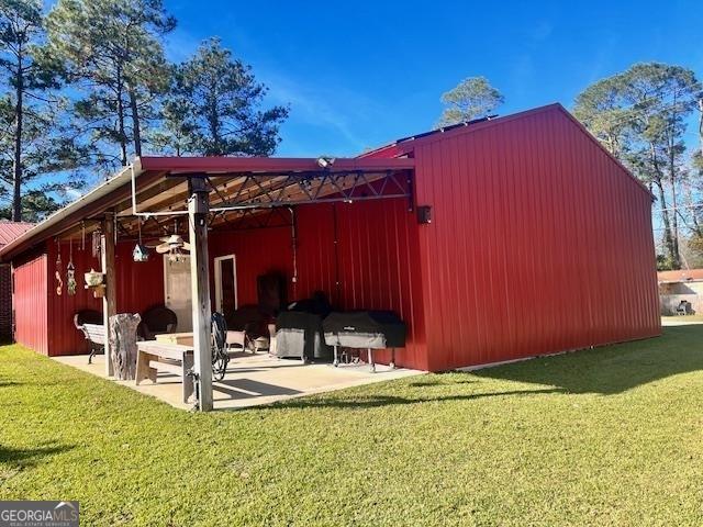 view of outbuilding with a yard