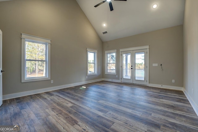 spare room featuring french doors, dark hardwood / wood-style floors, high vaulted ceiling, and a healthy amount of sunlight