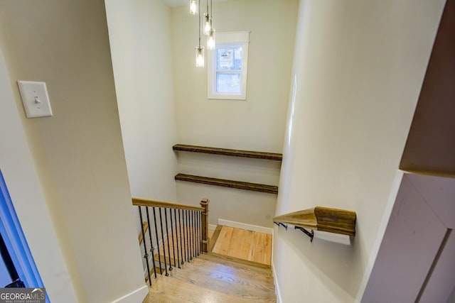 stairway featuring wood-type flooring