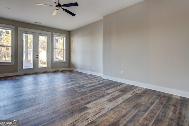 empty room featuring dark hardwood / wood-style flooring, ceiling fan, and french doors