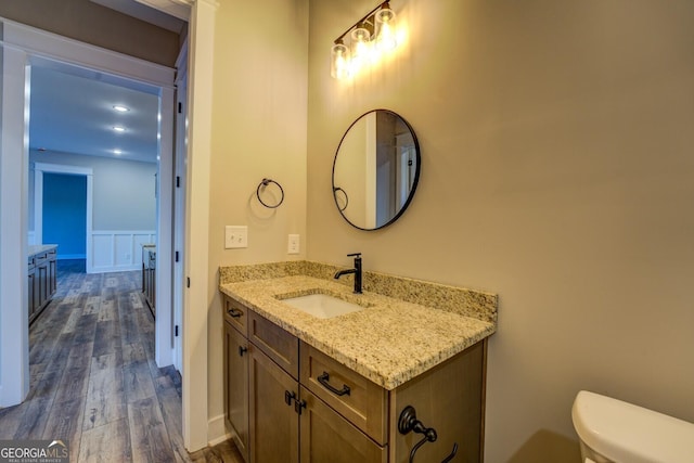 bathroom featuring vanity, toilet, and wood-type flooring