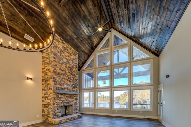 unfurnished living room featuring wood ceiling, a stone fireplace, high vaulted ceiling, and a healthy amount of sunlight