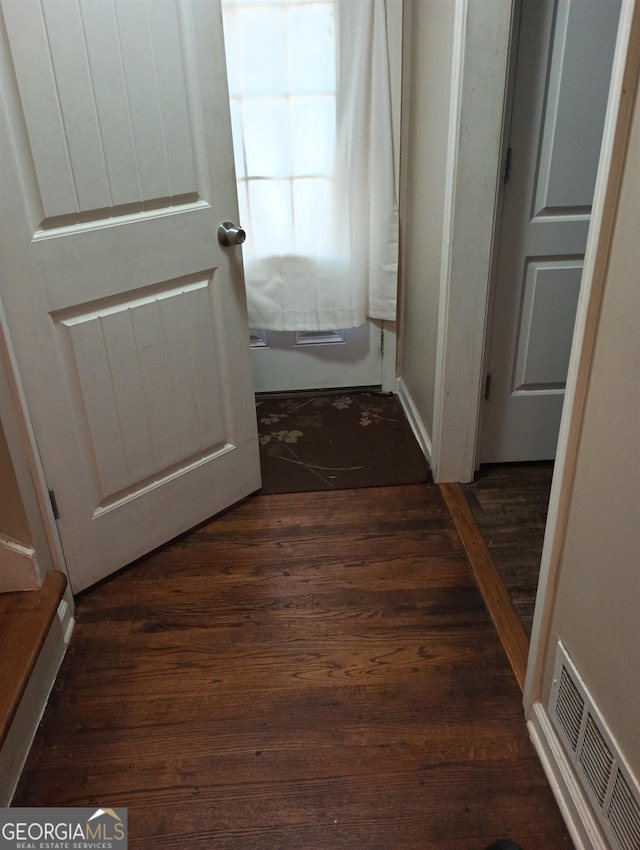 hallway with dark hardwood / wood-style flooring