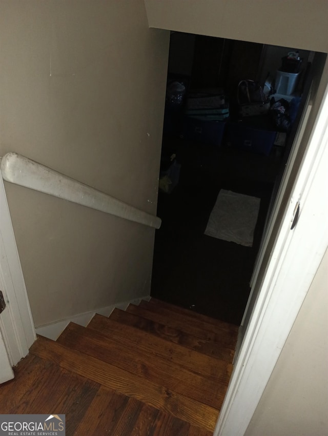 staircase with wood-type flooring