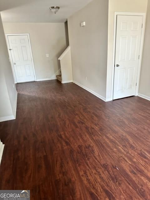 unfurnished room with dark hardwood / wood-style floors