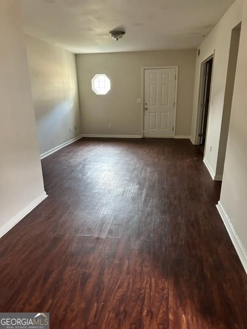 spare room featuring dark hardwood / wood-style flooring