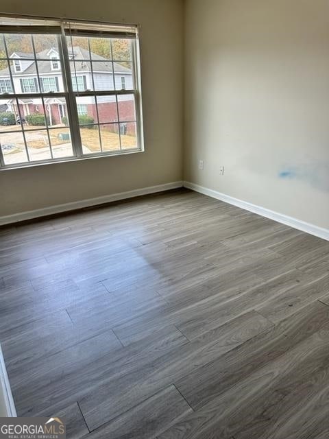 empty room featuring dark wood-type flooring