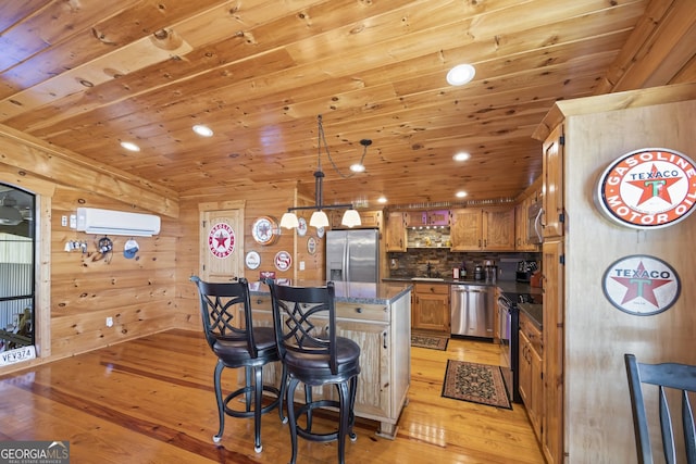 kitchen featuring appliances with stainless steel finishes, light hardwood / wood-style floors, a wall mounted AC, wooden walls, and wood ceiling