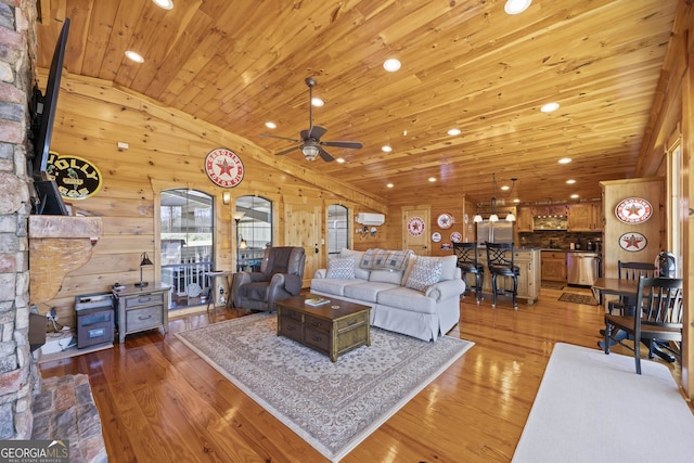 living room with wooden ceiling, a fireplace, wooden walls, wood-type flooring, and ceiling fan