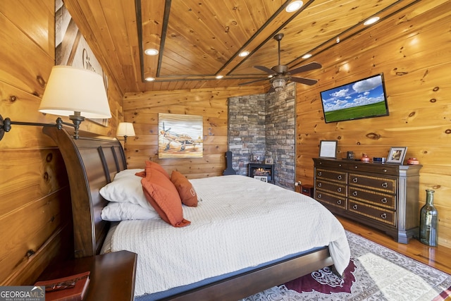 bedroom with wood walls, dark hardwood / wood-style floors, and wood ceiling