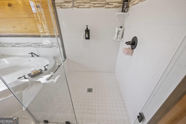 bathroom featuring tile flooring and a tile shower