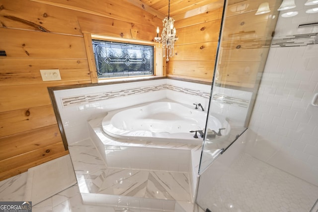 bathroom featuring an inviting chandelier, tile flooring, and tiled bath