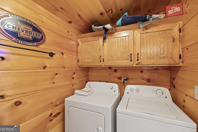 clothes washing area featuring wooden walls, cabinets, separate washer and dryer, and wood ceiling