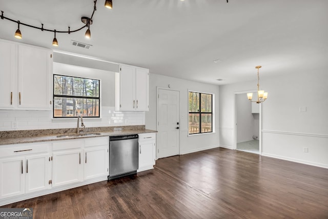 kitchen featuring dark hardwood / wood-style flooring, a healthy amount of sunlight, white cabinets, a chandelier, and stainless steel dishwasher