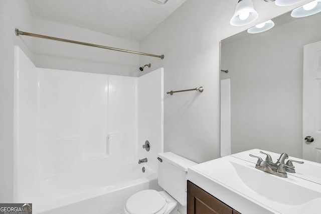 full bathroom featuring vanity, a textured ceiling, toilet, and tub / shower combination