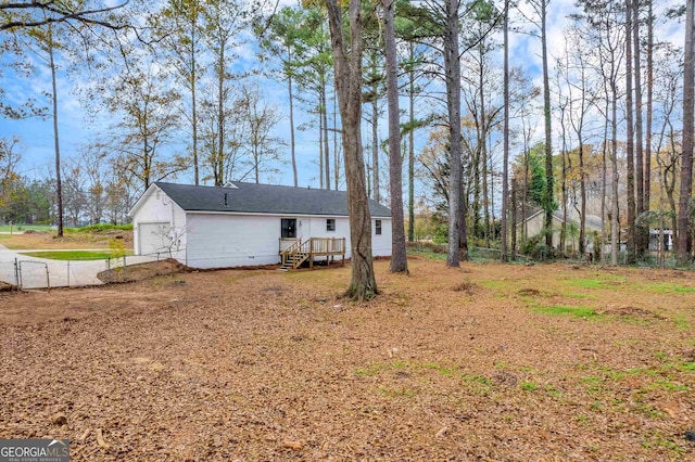 view of yard featuring a wooden deck and a garage