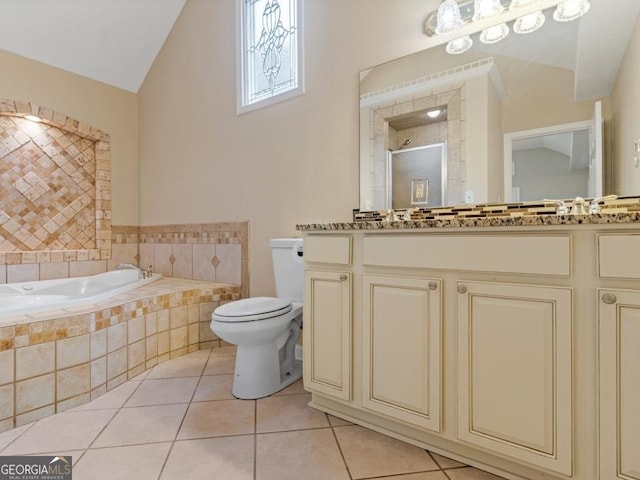 bathroom featuring a relaxing tiled bath, tile flooring, large vanity, and toilet