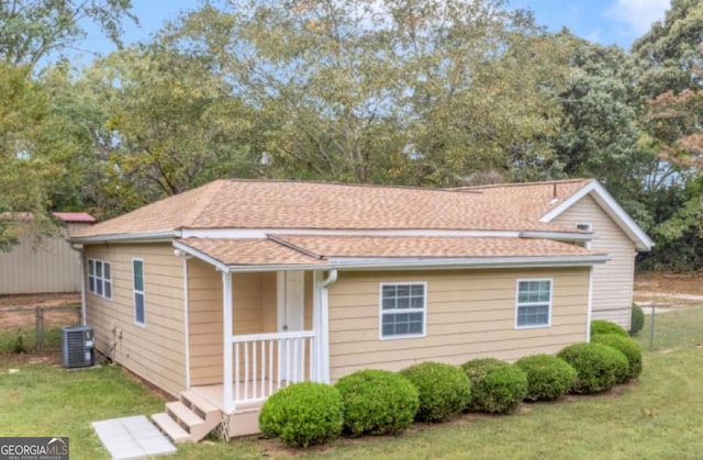 view of front of home featuring central AC and a front lawn